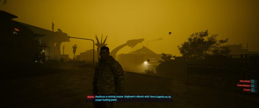 Cyberpunk 2077 screenshot: NPC Aaron, standing in the rain, with black buildings silhouetted against the gloomy mustard yellow sky, says that Dogtown is a vibrant place. 