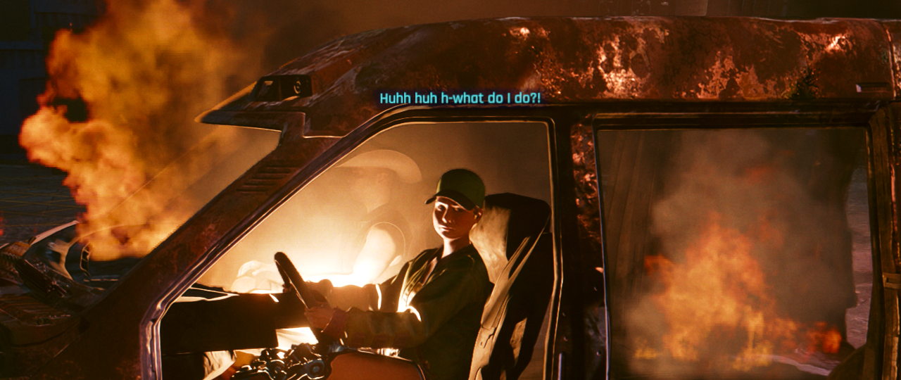 Cyberpunk 2077 screenshot: a woman is sitting in an exploded, actively, burning car. She's unharmed. Her hands are on the wheel. She's looking at the player. She's saying "what do I do?" The car doors have flown off and nothing is preventing her from stepping out of the burning wreck.